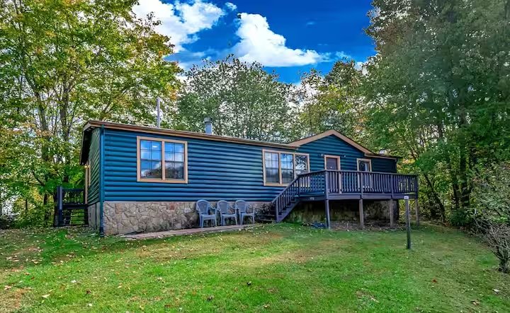 House exterior in summer, surrounded by trees, at Mountain Retreat